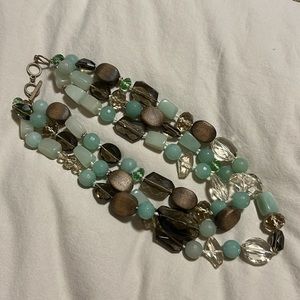 Triple strand necklace in wood and brown, amber and green glass beads.